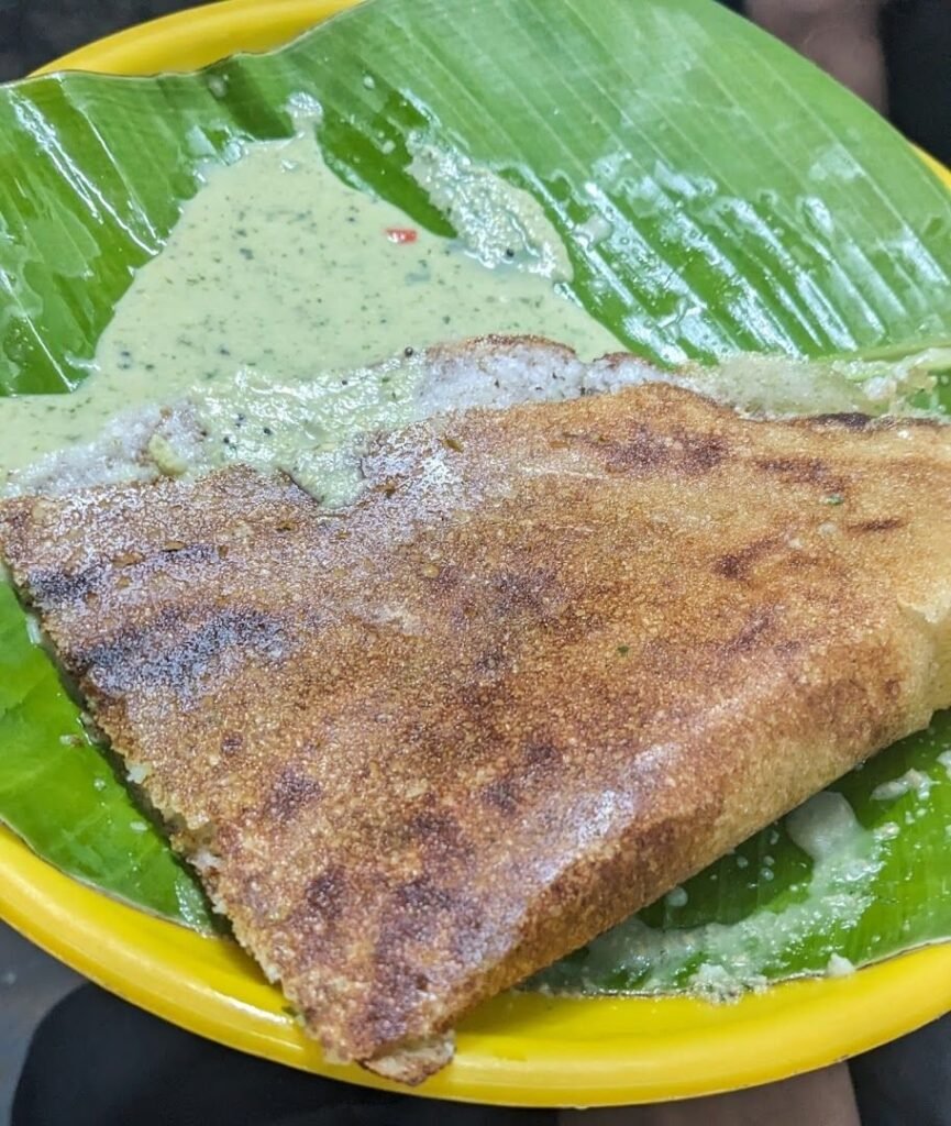 Crispy benne dosa served on banana leaf with coconut chutney at Siddappa Hotel Sampangi Rama Nagara