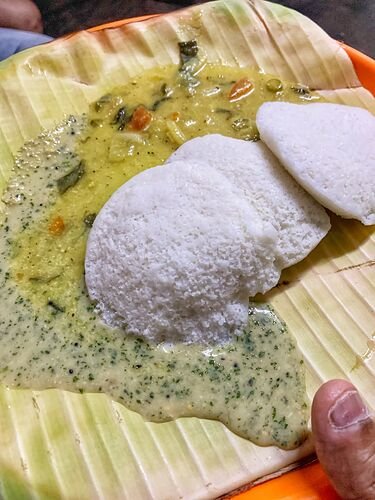 Soft idli served with coconut chutney on banana leaf at Siddappa Hotel Sampangi Rama Nagara