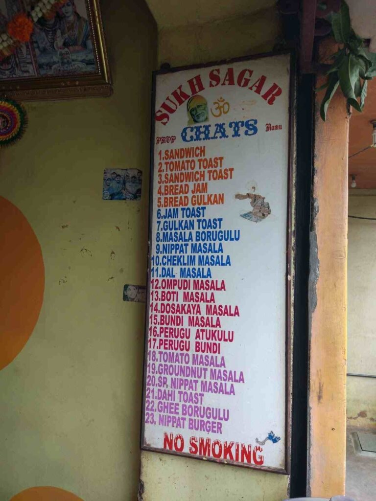 Sukh Sagar Hindupuram menu board displaying toast items and traditional masala snacks