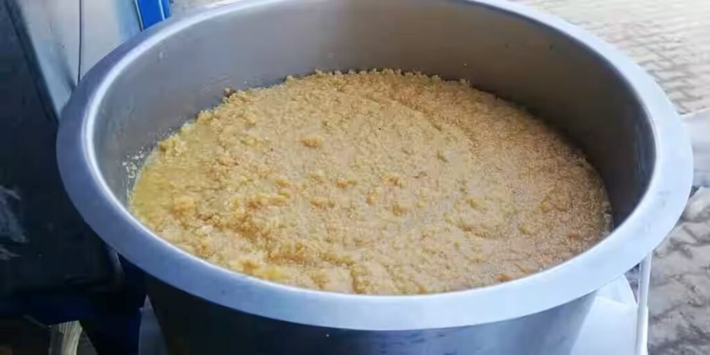 Traditional preparation of Azeem Guvvalacheruvu Palakova in a large cooking vessel