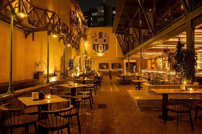 Acre Bengaluru evening ambience with cozy lighting and elegant open courtyard seating in North Bangalore.