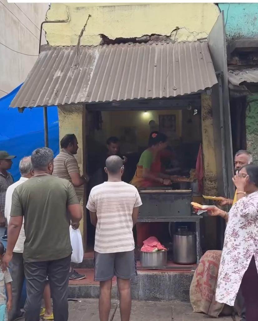 Customers waiting outside Mahesh Hotel in Doddaballapur during busy morning breakfast hours.