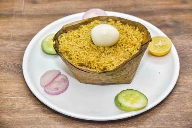 Hoskote style chicken biryani served in donne with boiled egg at Ravi Kabab Centre
