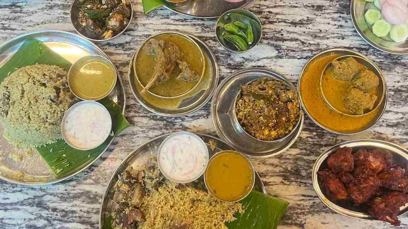 Traditional naati oota non-veg meal with biryani, chicken fry, mutton curry and side dishes at Hotel Aditya Mahalaxmipuram Bangalore