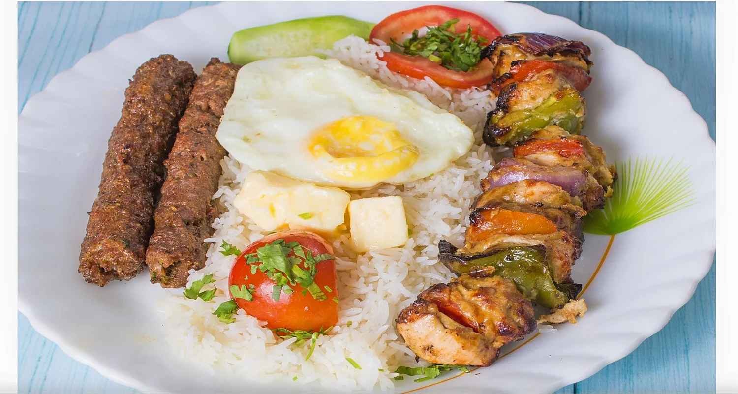 Chelo kebab with butter rice, fried egg, seekh kebab and grilled chicken at Peter Cat Kolkata