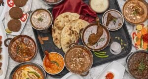 Traditional Mughlai food platter at Karim’s Delhi including naan, chicken curry, kebabs, and rich Mughlai gravies.