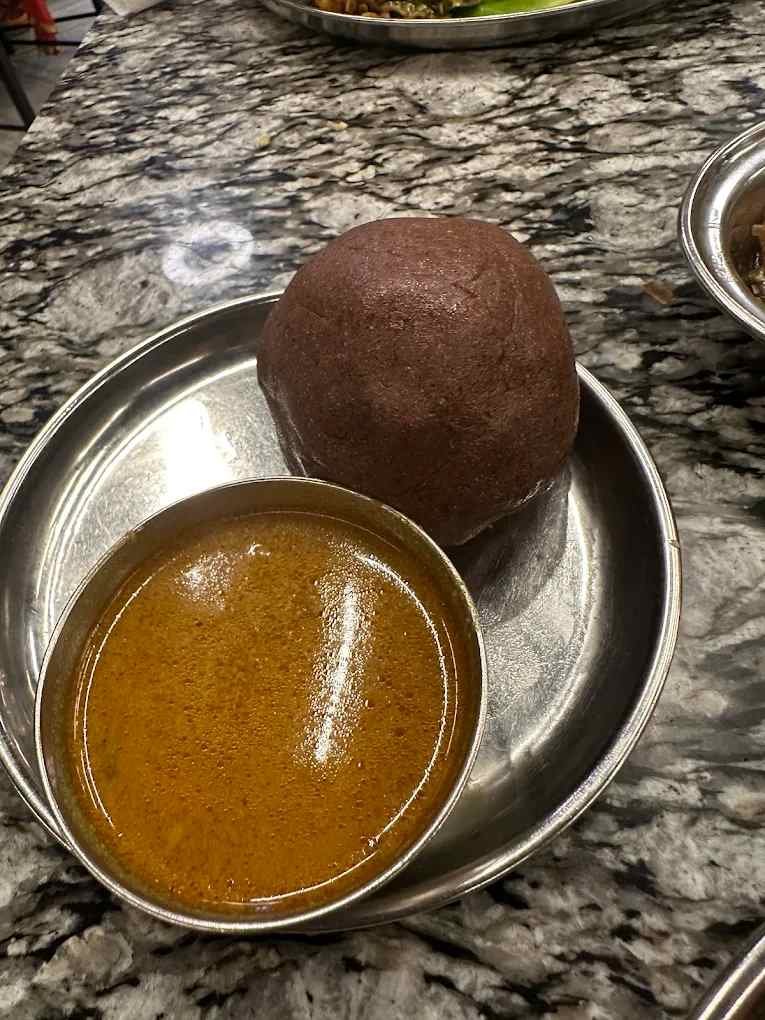 Ragi mudde served with mutton curry at Hotel Aditya Mahalaxmipuram Bangalore