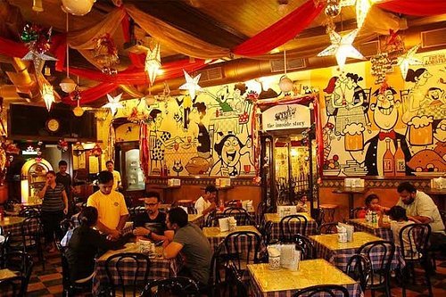 Cafe Mondegar interior ambience with Mario Miranda murals and lively seating