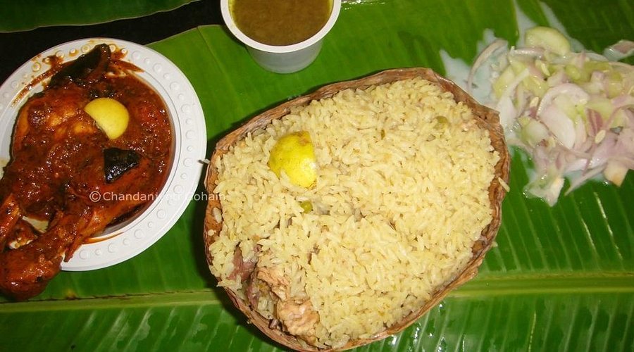 Traditional Chicken Donne Biryani served in leaf bowl with gravy at Shivaji Military Hotel Bengaluru.