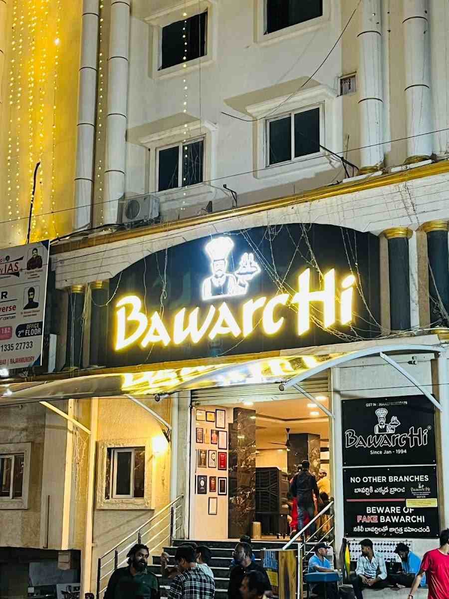 Bawarchi Restaurant Hyderabad exterior view with illuminated signboard at night