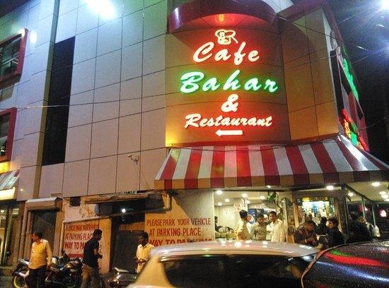 Cafe Bahar Restaurant exterior view at Basheerbagh Hyderabad with bright signboard at night