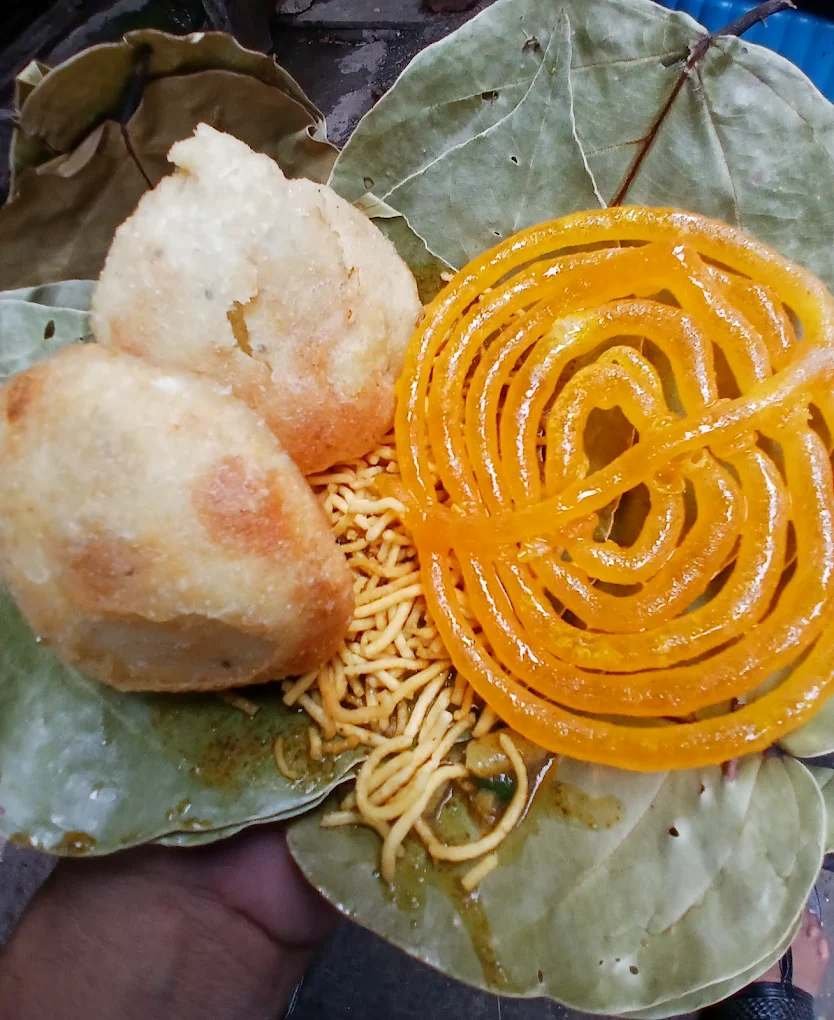 Club kachori with aloo curry bhujiya and jalebi served on leaf plate Kolkata street food