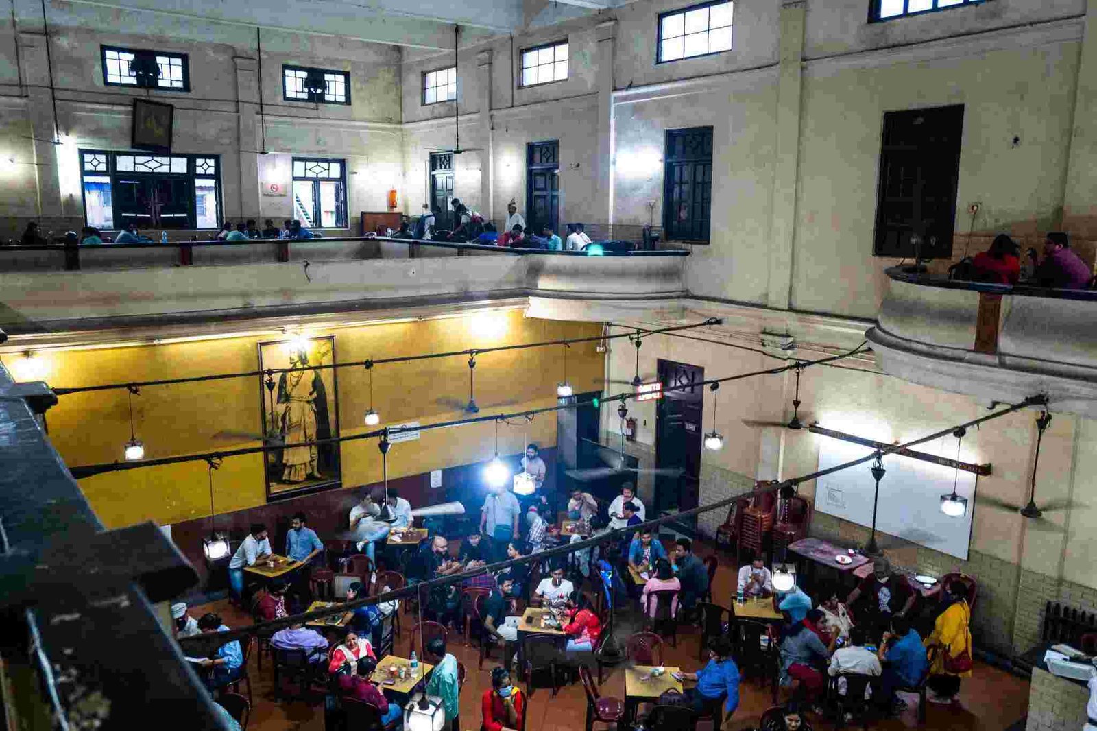 Interior view of Indian Coffee House Kolkata with vintage seating and crowded dining hall
