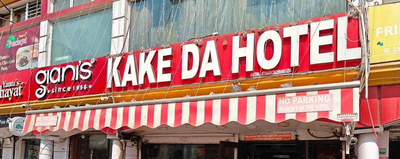 Kake Da Hotel exterior in Connaught Place Delhi with red signage and striped awning