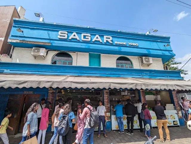 Crowd gathered outside Sagar Juice Centre in Rajajinagar Bangalore during daytime