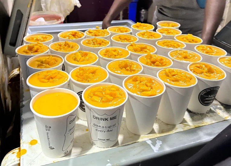 Fresh mango juice cups with pulp served at Sagar Juice Centre Bangalore