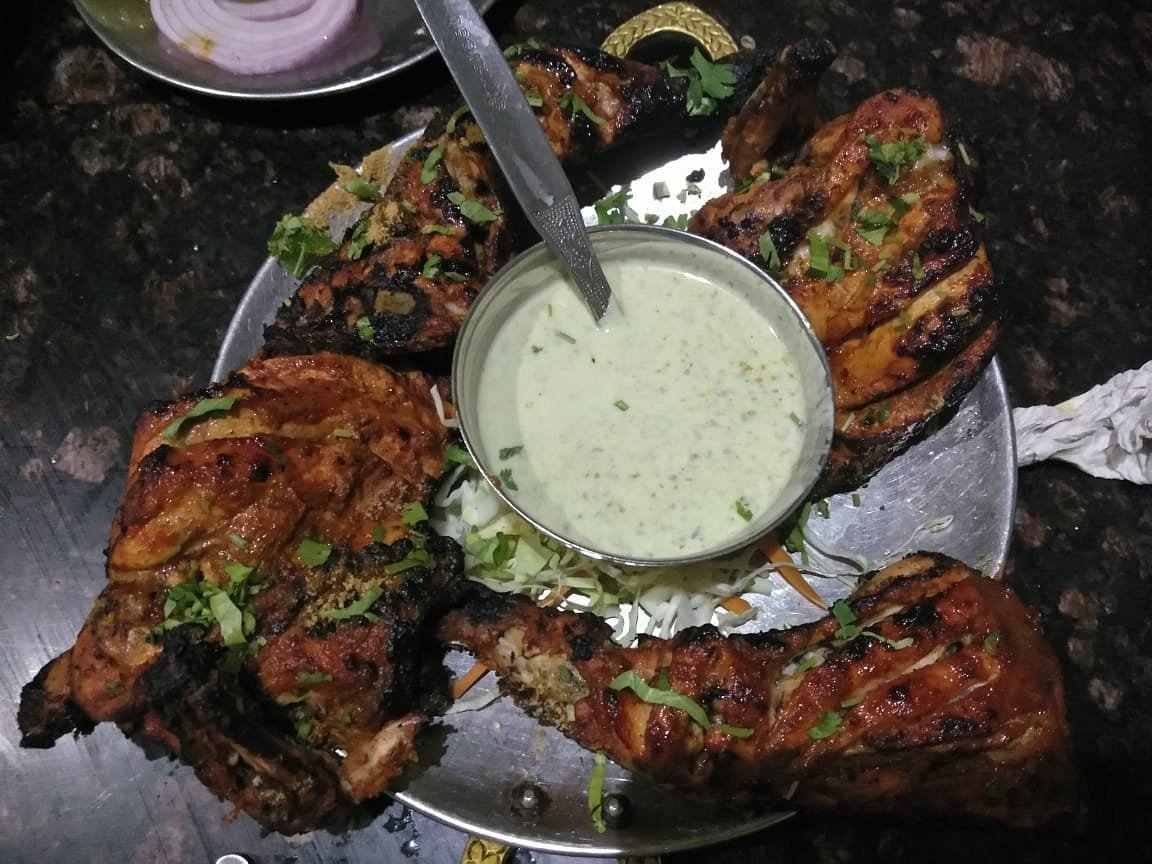 Grilled chicken kebabs served at Cafe Bahar Hyderabad with mint chutney