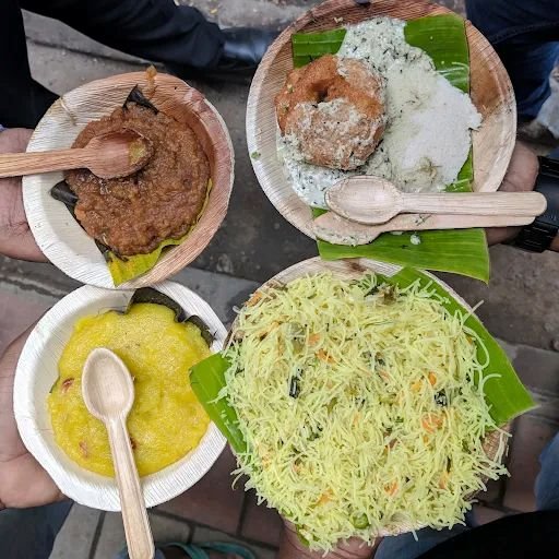Idli vada with chutney and khara bath at Veena Stores Bangalore served fresh on banana leaf plates