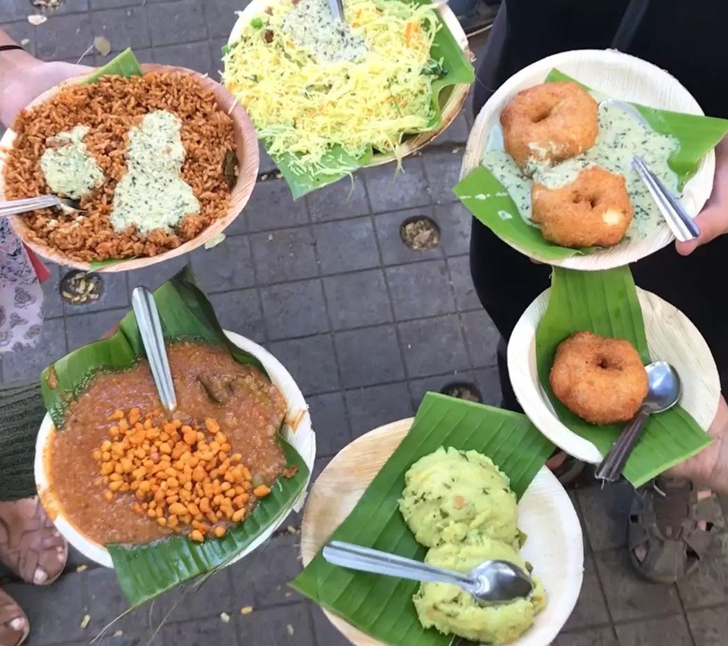 South Indian breakfast at Veena Stores featuring idli vada chutney shavige bath and avalakki bath served on banana leaf plates