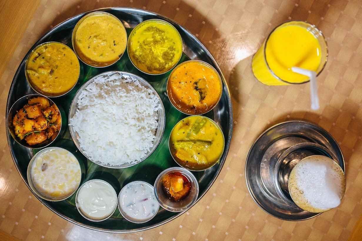 Saravana Bhavan Chennai South Indian meals served on banana leaf with rice, sambar, curries and sweets