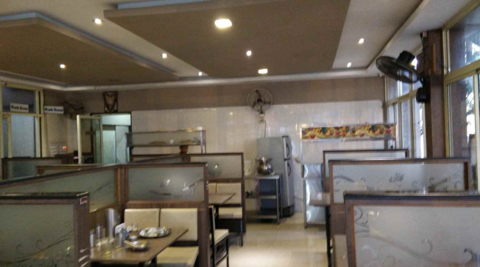 Interior seating area of Gayatri Tiffin Room Bangalore with simple dining tables and clean setup