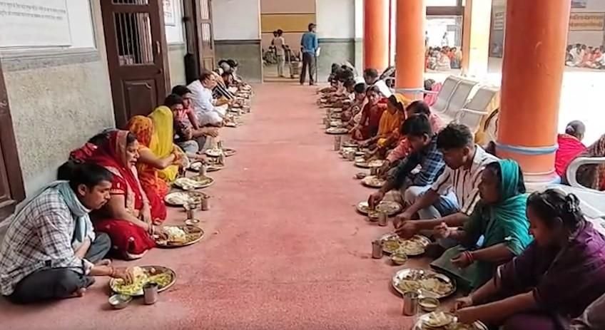 Devotees sitting in rows and eating sattvic prasad meal at Shri Ram Rasoi Ayodhya near Ram Mandir