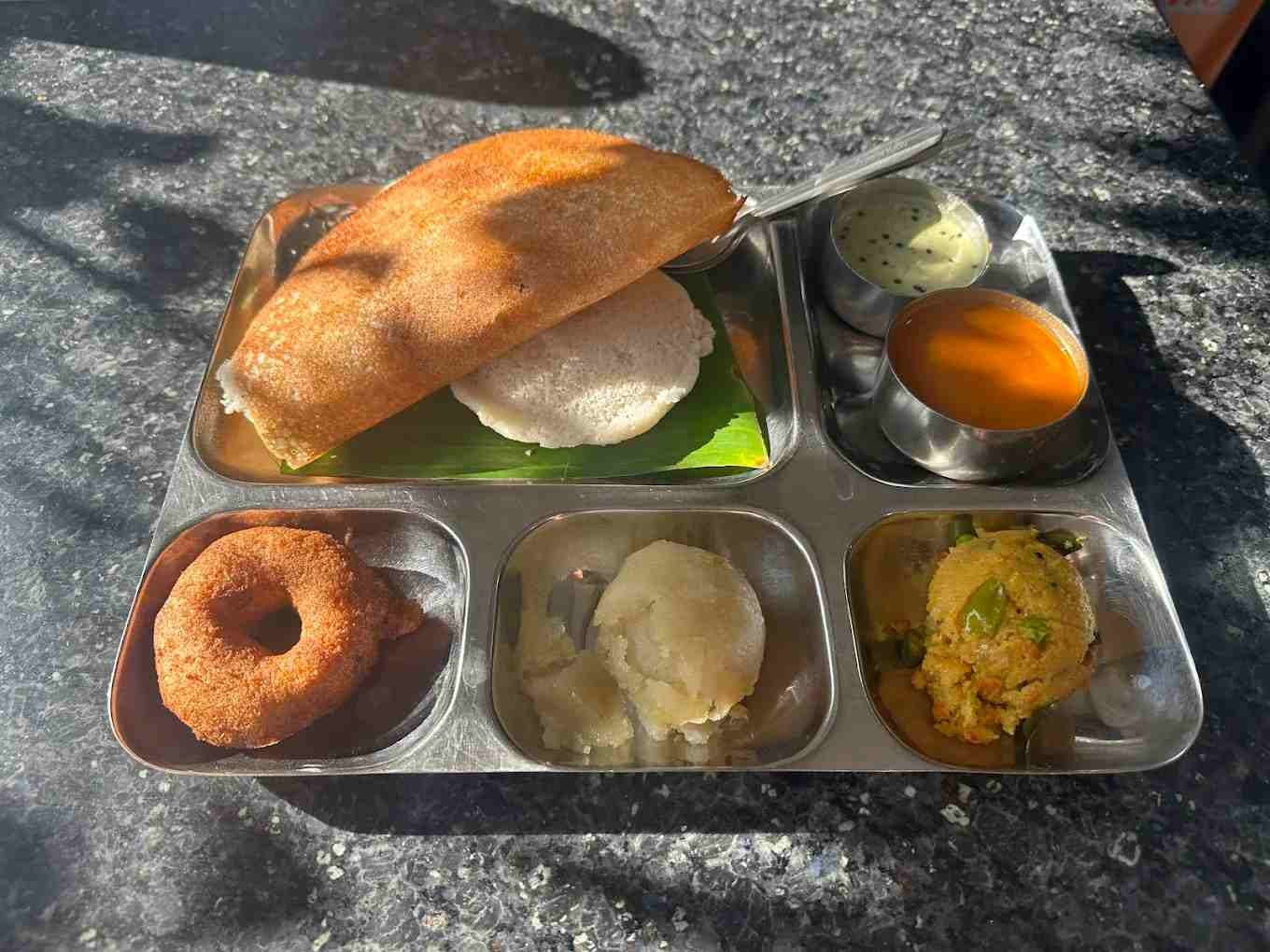 Traditional Karnataka combo tiffin at Maddur Tiffanys Mysore featuring dosa, idli, vada, kesari bath, khara bath, chutney, and sambar.