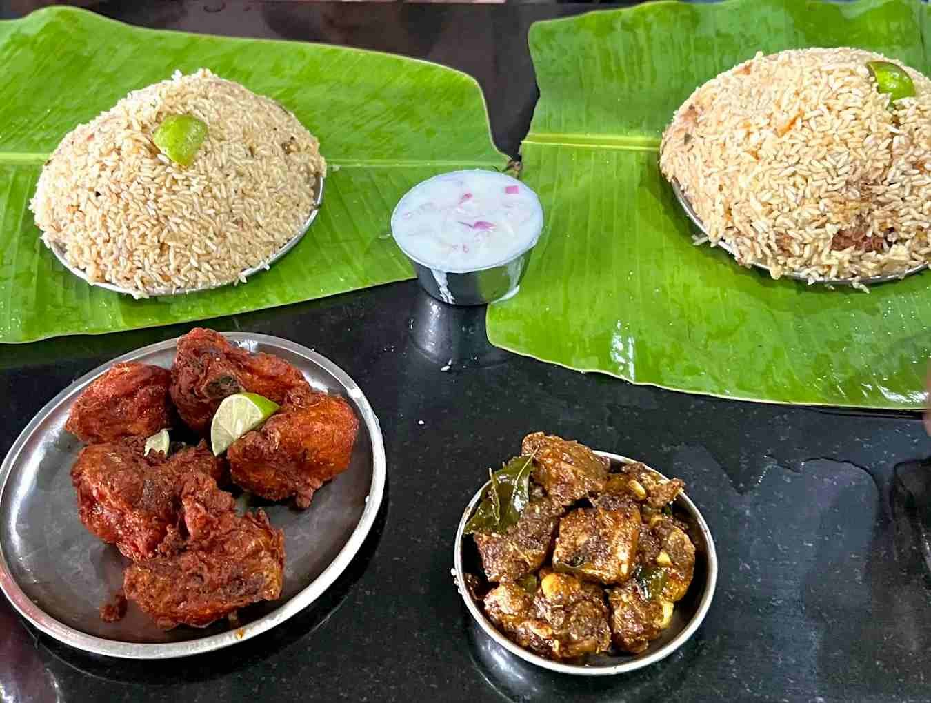 Chicken biryani and spicy Andhra chicken dishes served on banana leaves at Hotel Navayuga Bangalore