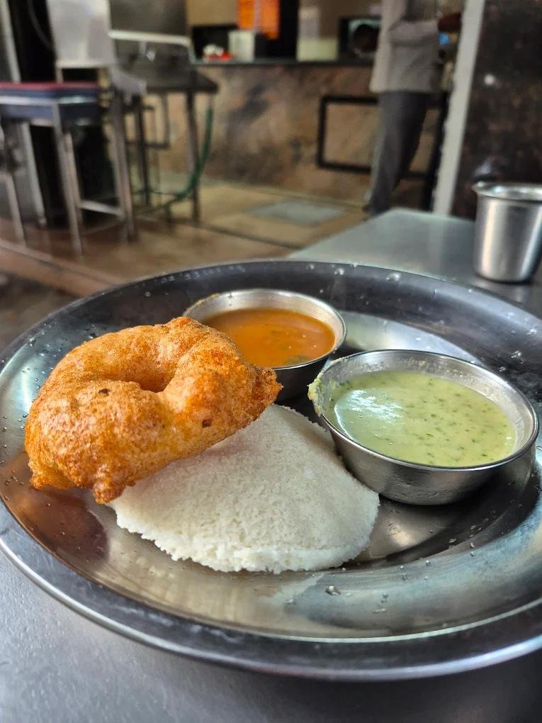 Soft idly and crispy medu vada served with sambar and coconut chutney at S N Refreshments JP Nagar.