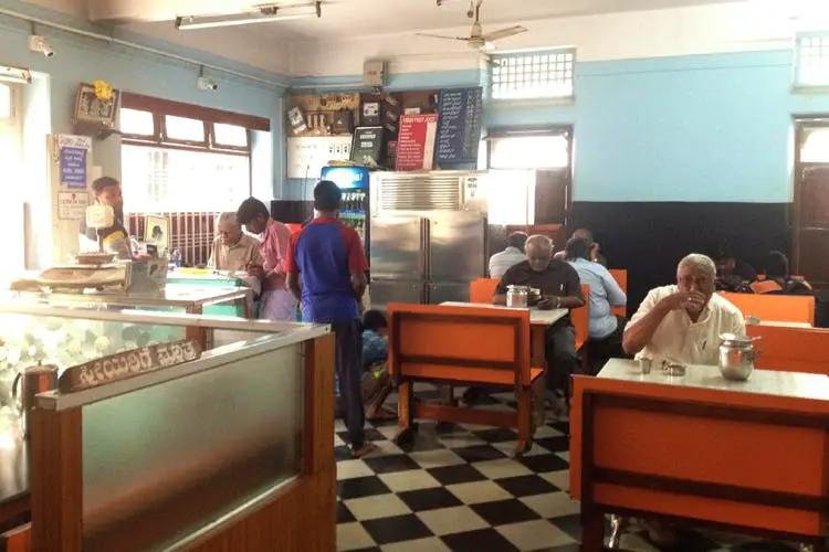 Maha Lakshmi Tiffin Room Basavanagudi interior with traditional seating and busy breakfast crowd
