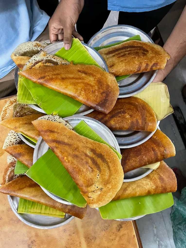 Crispy masala dosas served on banana leaf plates at Udupi Sri Krishna Bhavan in Balepet Bengaluru