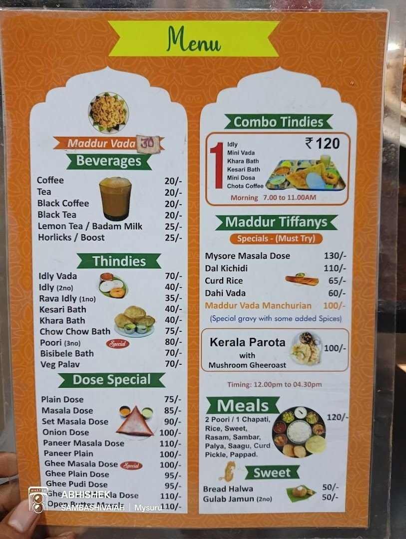 Menu board at Maddur Tiffanys Mysore displaying breakfast items, dosas, combo tiffins, beverages, meals, sweets, and Maddur Vada specials with prices.
