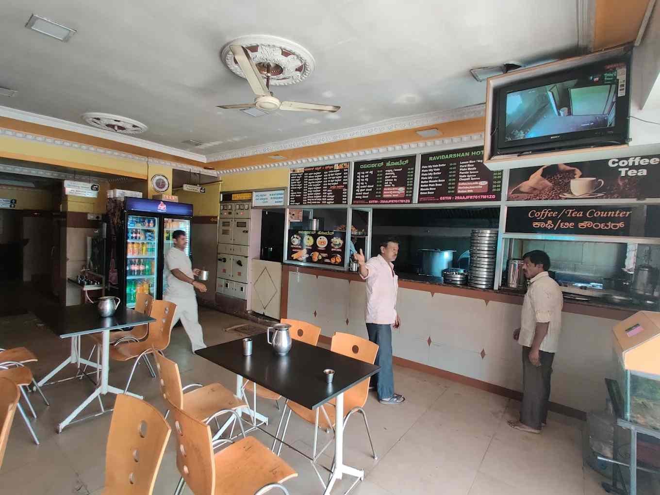 Interior seating area of Ravidarshan Hotel Bengaluru with traditional dining setup and coffee counter