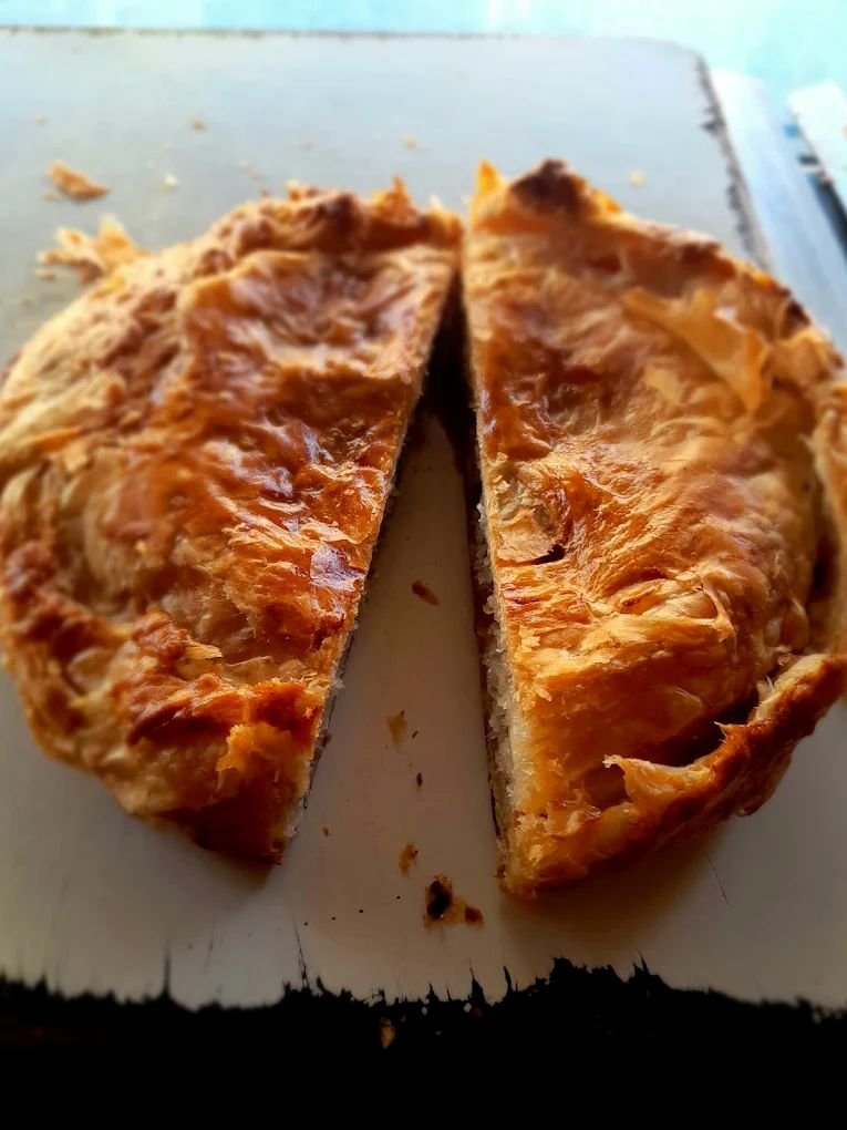 Freshly baked dilpasand pastry from Shwetha Bakery with flaky golden layers and sweet coconut filling.