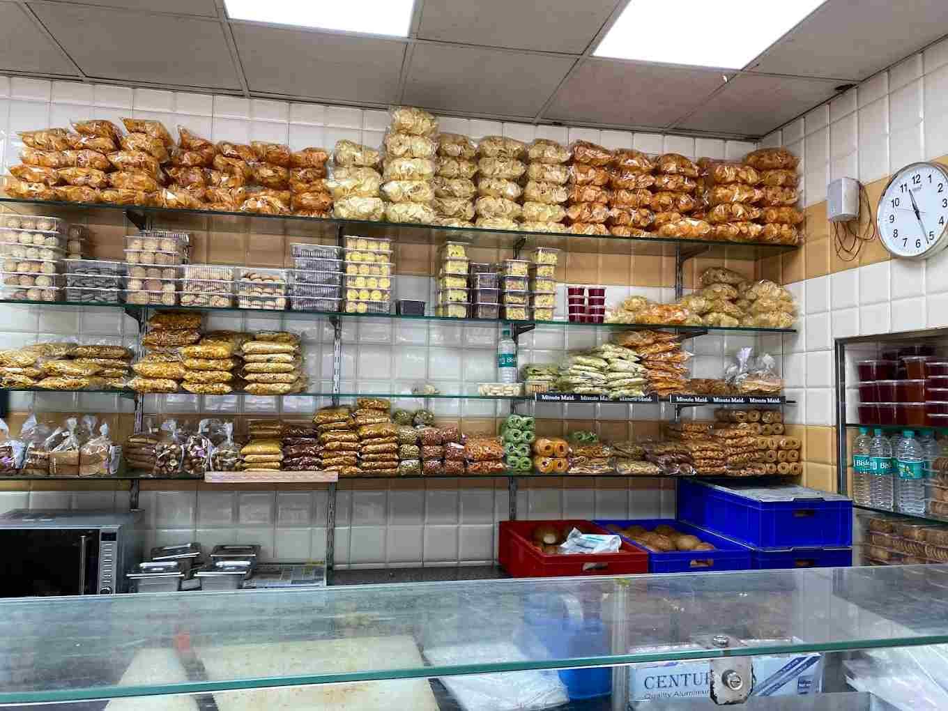 Shelves filled with biscuits, snacks, cookies, and bakery items inside Sri Jayalakshmi Bakery Bengaluru.