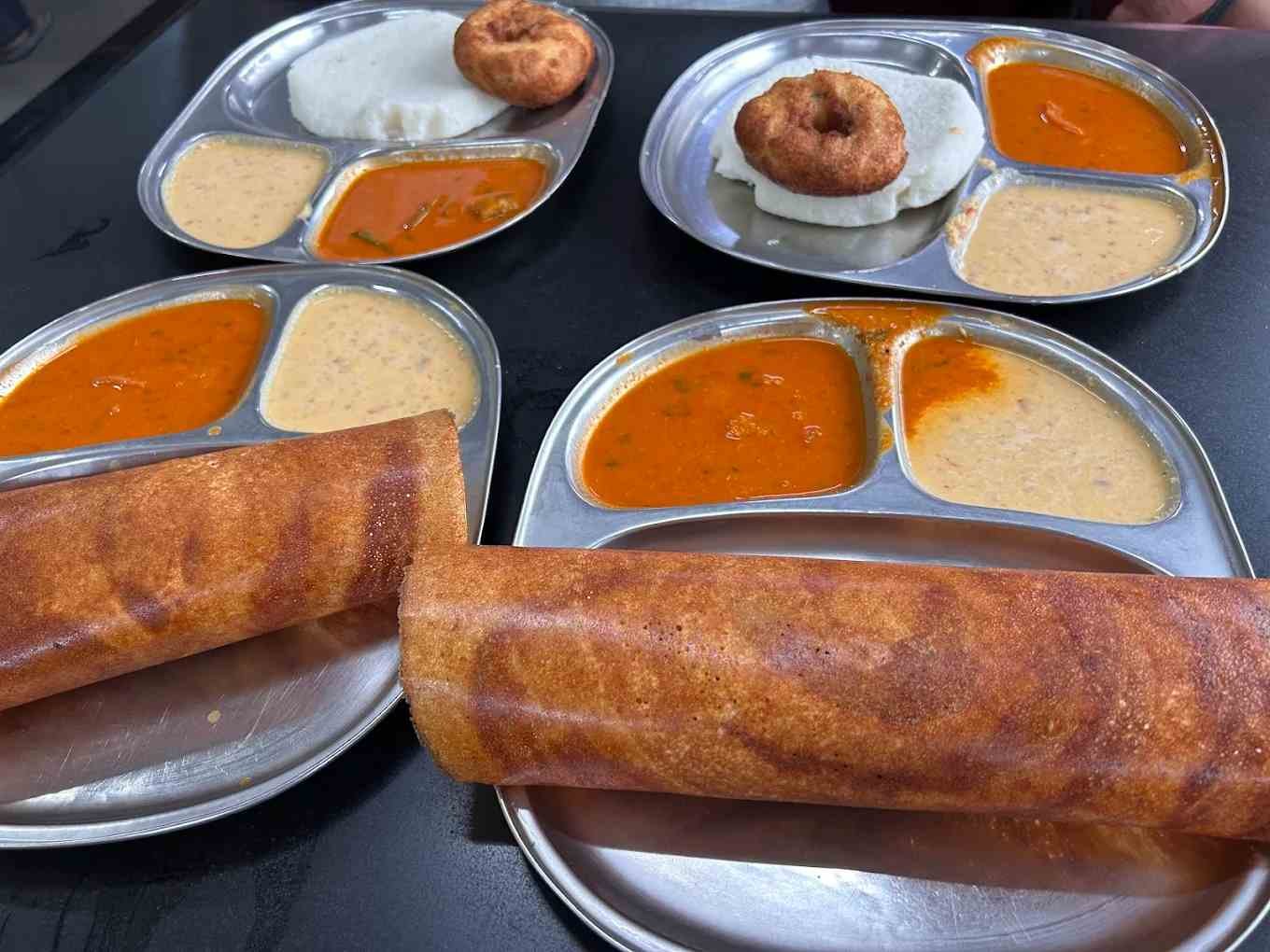 Crispy masala dosa, idli and medu vada served with chutney and sambar at Pavithra Idli Hotel in Tumakuru.
