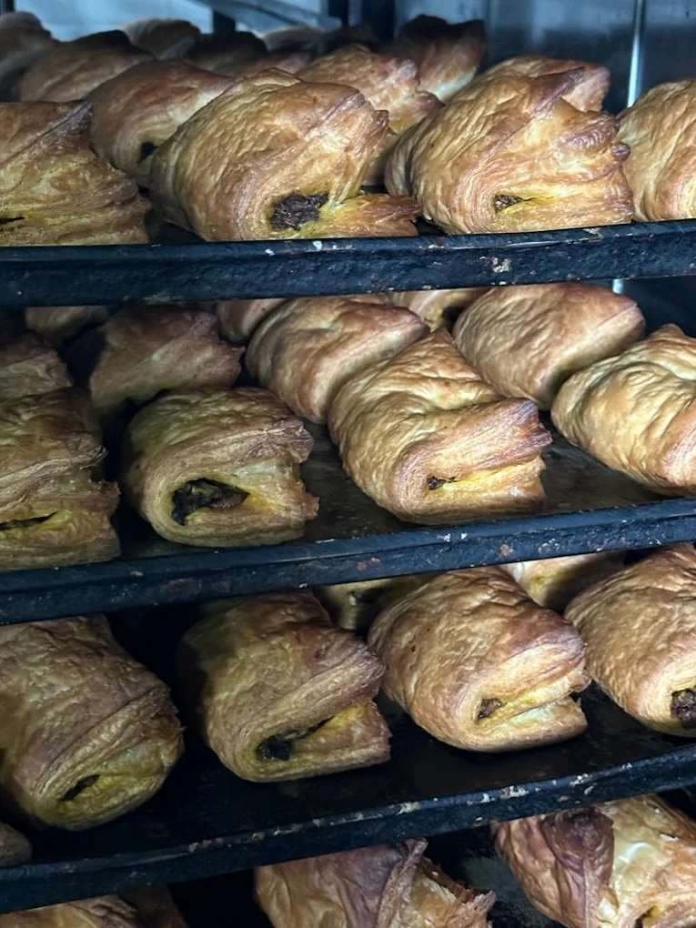 Freshly baked capsicum puffs arranged on bakery trays at Sri Srinivasa Brahmins Bakery, Bengaluru.