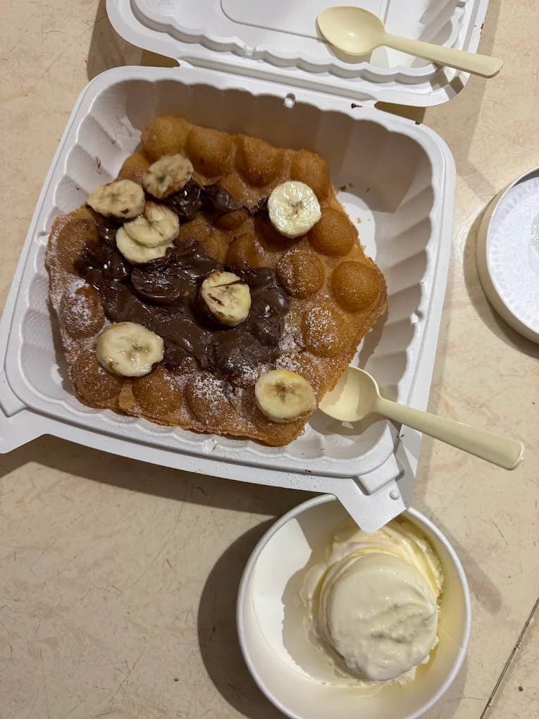 Bubble waffle topped with chocolate spread and banana slices at Lakeview Milkbar Bengaluru