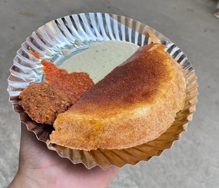 Crispy and fluffy Mulbagal Dosa served with coconut chutney, red chutney, and vada at Prasad Hotel.