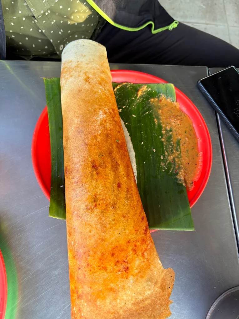 Crispy golden masala dosa served on a banana leaf at Shri Renukamba Thatte Idli in Bidadi.