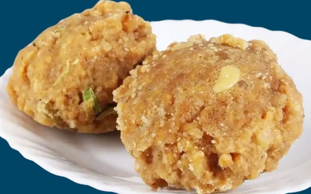 Famous Tirupati Laddu prasadam with cashews and raisins, offered at Tirumala Venkateswara Temple in Andhra Pradesh.
