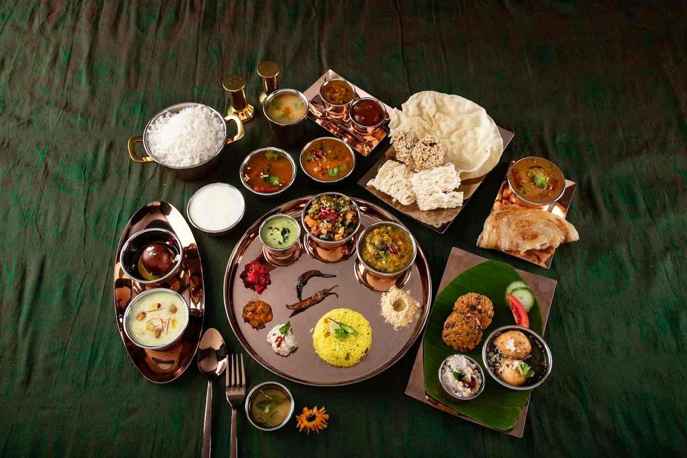 Traditional Karnataka vegetarian thali served at Atithyaa restaurant with rice, curries, sweets, papad, and regional specialties.
